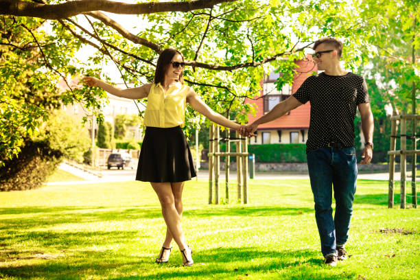 istock Couple holding hands in park. 1160127052