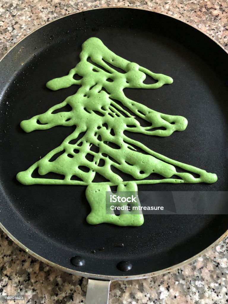 Image Of Green Pancake Shaped As Christmas Tree Cooking In Nonstick Frying  Pan For Childrens Breakfast On Xmas Day Christmas Tree Pancakes Ready To Be  Decorated With Fruit Baubles And Star Shaped