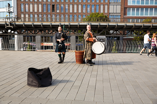 Hamburg, Germany - August 17, 2016 - The street musicians in traditional costumes playing bagpipe and drums.