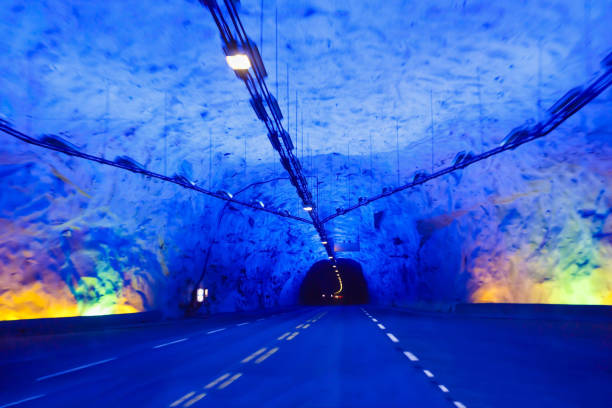 лаердальский туннель с красочными огнями в норвегии - scandic стоковые фото и изображения
