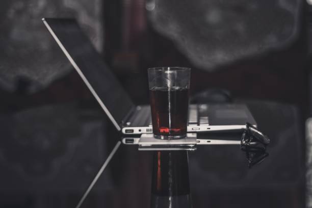 istock Black tea and laptop on a glass table 1160140472