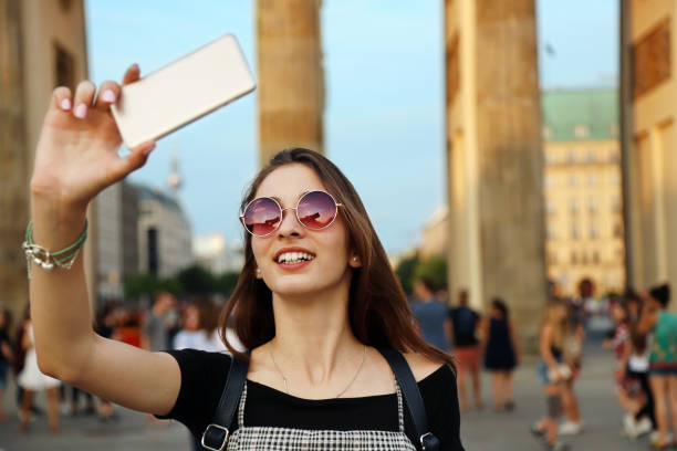 istock Happy girl taking a selfie with a smartphone 1160141228