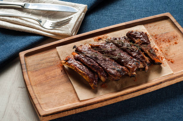 istock Pork ribs served on a wooden Board in the restaurant 1160142530