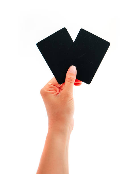 Female hand showing two black cards, isolated on white background.