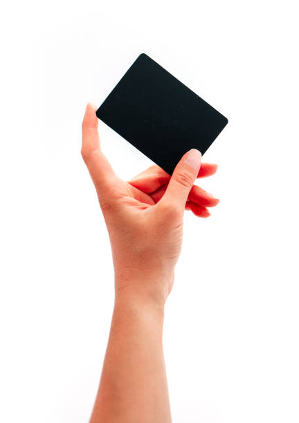 istock Female hand showing a black card, isolated on white background. 1160147497