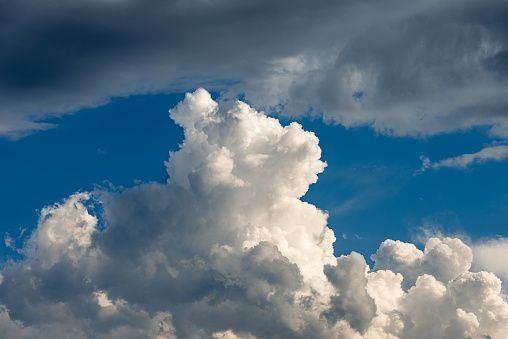 Close-up of a puffy white clouds in the blue sky, cumulonimbus