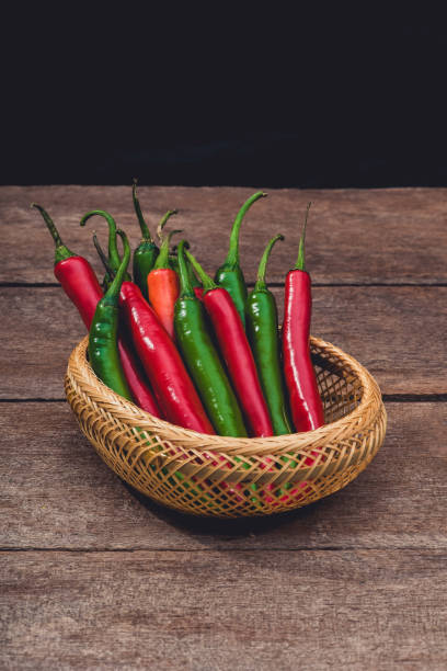 istock Red and green chili on wooden table background 1160151180