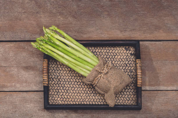 istock Fresh Asparagus in wooden plate 1160152183