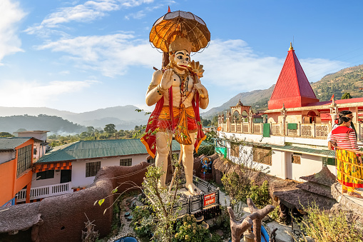 Uttarakhand, India, October 24,2018: Giant statue of Lord Hanuman with view of temple premises of Hanuman Garhi Hindu temple at Nainital, Uttarakhand India.