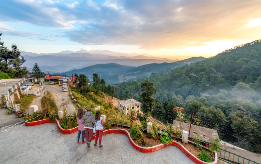 Uttarakhand, India, October 21,2018: Tourists enjoy sunrise view from hotel terrace with view of Himalaya mountain range at Kausani Uttarakhand India.