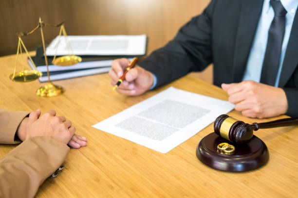 istock Midsection Of Judge Sitting By Client At Desk 1160169118