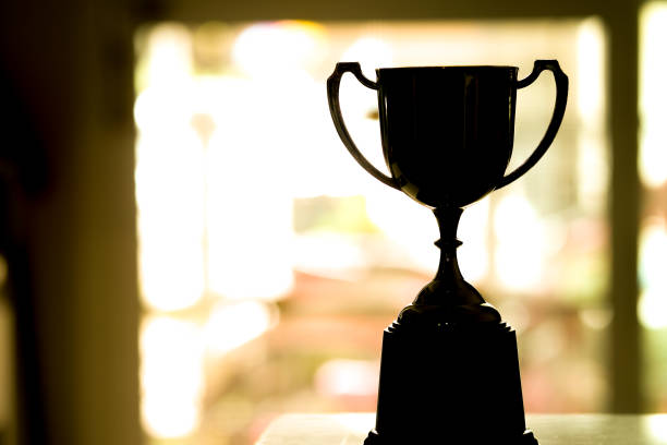 istock Silhouette Trophy competition in the dark on the abstract blurred light background with copy space 1160169517
