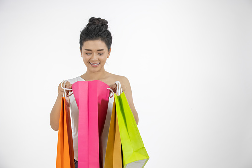 Asian women Beautiful girl is holding shopping bags and smiling