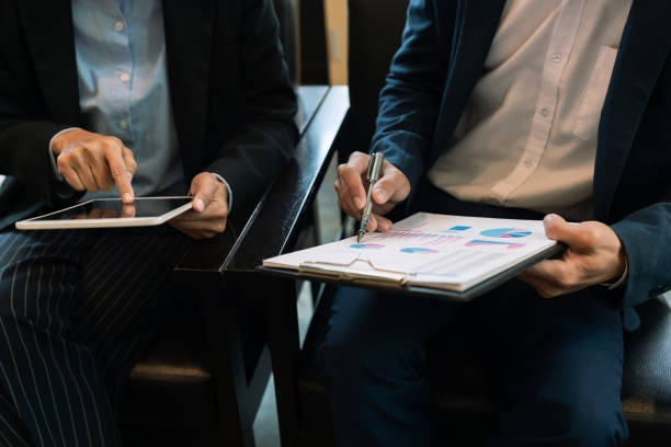 istock Midsection Of Colleague With Digital Tablet Analyzing Chart In Office 1160170556