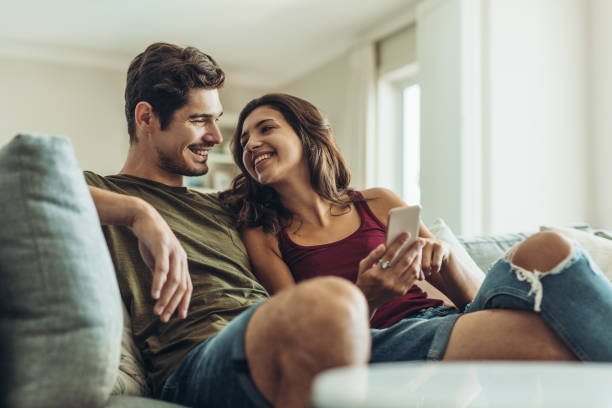 istock Loving couple relaxing on sofa 1160172748