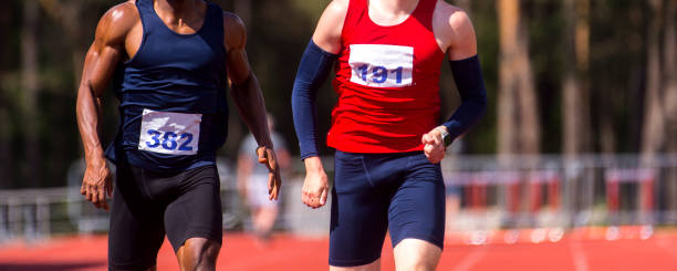istock Midsection Of Sprinters Running On Sports Track 1160173696