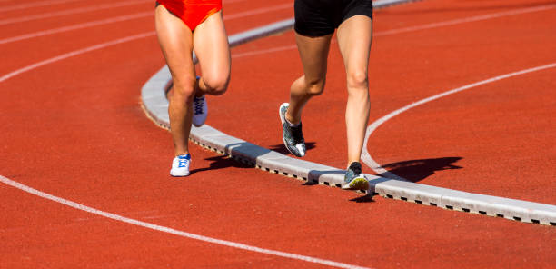 istock Low Section Of Sprinters Running On Sports Track 1160174243
