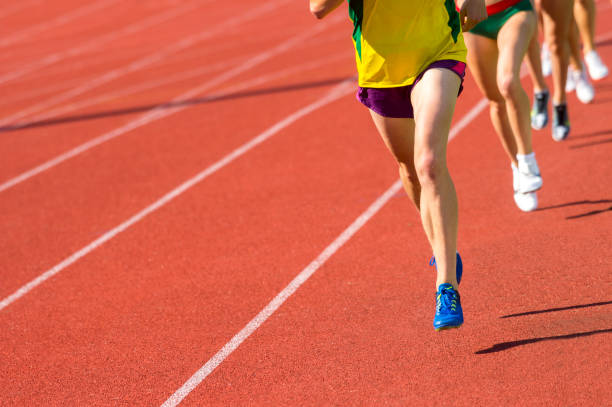istock Low Section Of Sprinters Running On Sports Track 1160174246