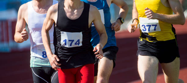 istock Midsection Of Men Running Marathon 1160174477
