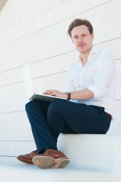 istock Handsome young man working on laptop outdoors 1160175996