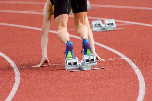 istock Low Section Of Sprinter Standing At Starting Line 1160176945