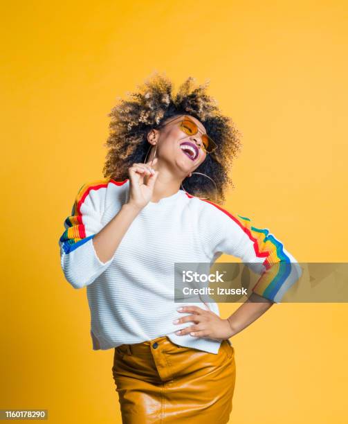 Stylish African Woman Enjoying Against Yellow Background Stock Photo - Download Image Now