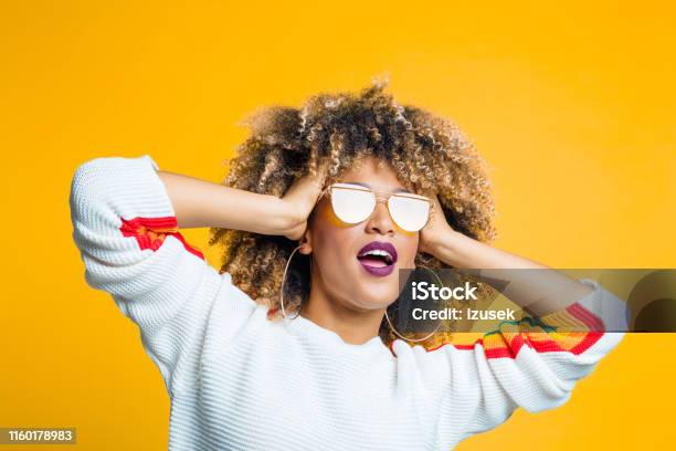 Funky Afro Girl Against Yellow Background Stock Photo - Download Image Now - Women, Sunglasses, Fashion