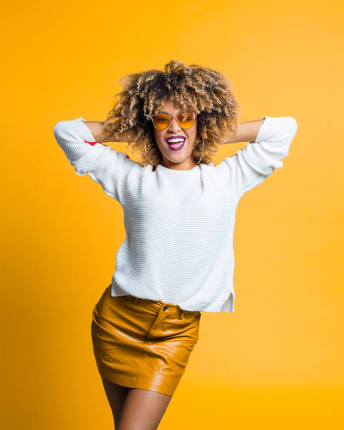 istock Beautiful afro woman posing against yellow background 1160179085