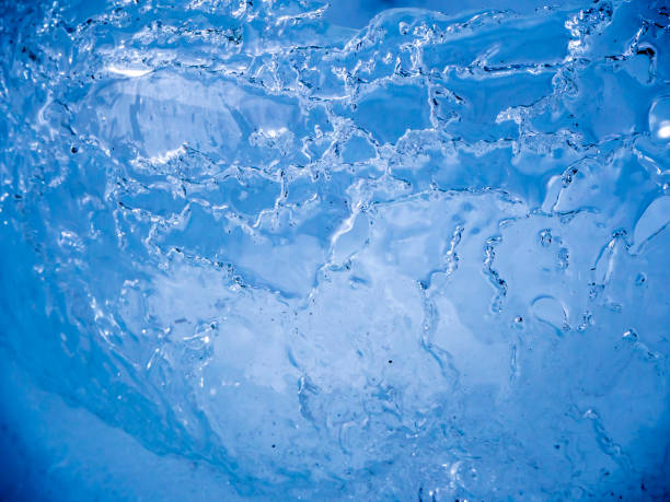 istock Ice surface shot up close with sun illuminating and melting the ice 1160179128
