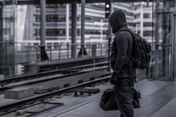 istock Dark hooded terrorist figure in empty urban surroundings 1160179164