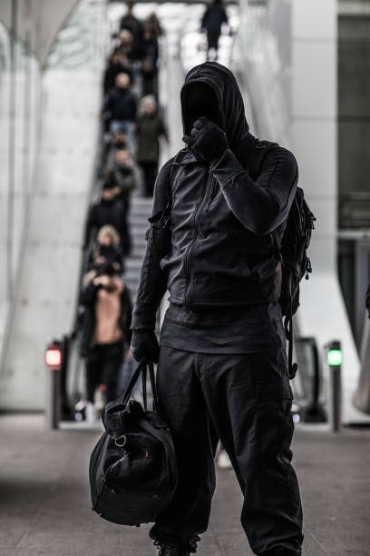 istock Dark hooded terrorist figure in empty urban surroundings 1160179306