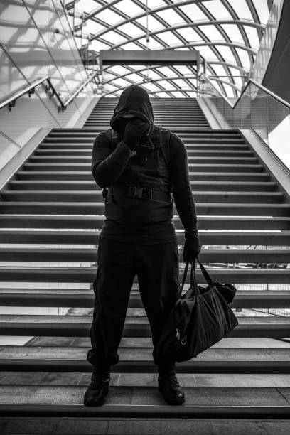 istock Dark hooded terrorist figure in empty urban surroundings 1160180087