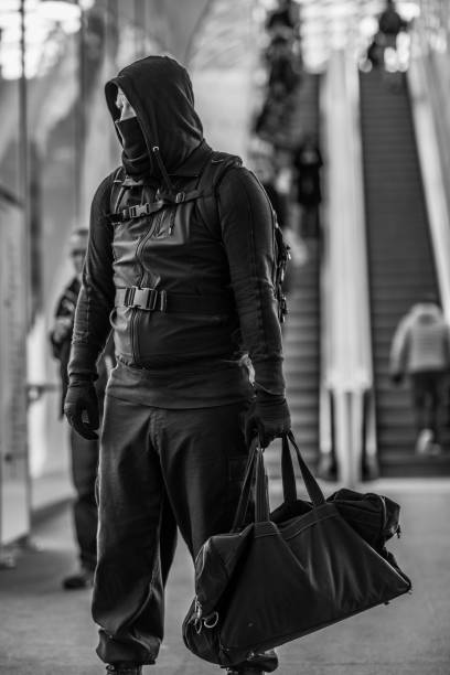 istock Dark hooded terrorist figure in empty urban surroundings 1160180114