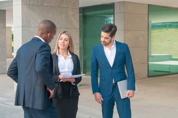 istock Three young business partners talking at office building 1160182483