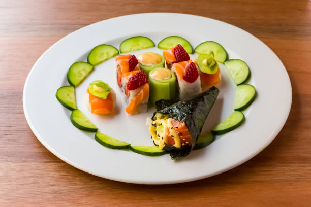 istock Bright color Sushi with fruit on a white plate 1160182697