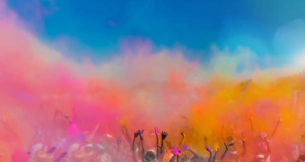 istock Crowd throwing bright colored powder paint in the air 1160182709