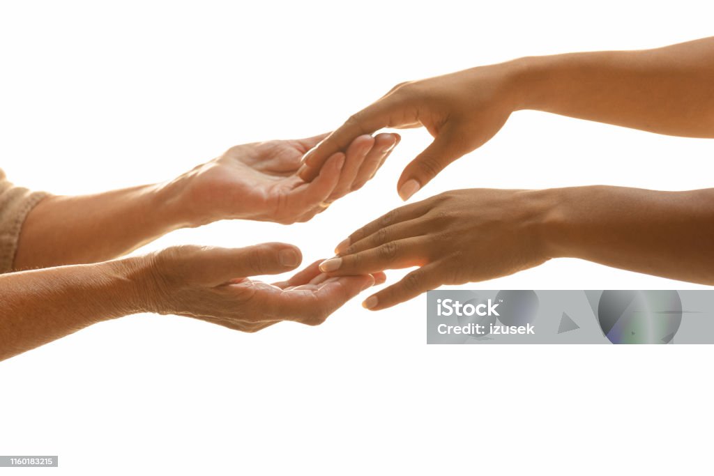 Helping elderly people Cropped shot of female nurse and senior woman's hands touching each other against white background 70-79 Years Stock Photo