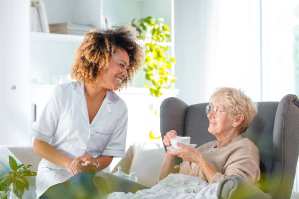 istock Friendly nurse with senior woman at home 1160183257