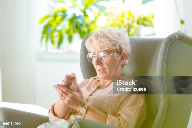 Elderly Woman Feeling Numbness In Her Hand Stock Photo - Download Image Now - Parkinson's Disease, Senior Adult, Arthritis