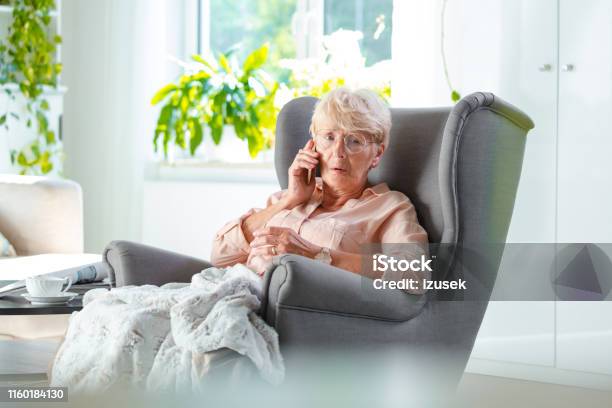 Elderly Lady Talking On Cell Phone Looking Worried Stock Photo - Download Image Now - Using Phone, Senior Women, Senior Adult