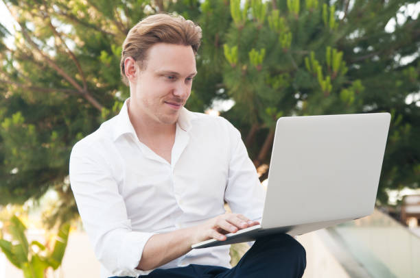 istock Content business man working on laptop in park 1160184135
