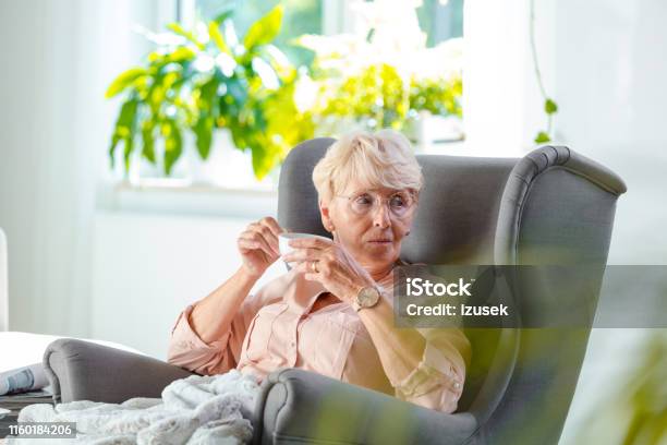 Elderly Lady Relaxing In An Armchair At Home Stock Photo - Download Image Now - Alzheimer's Disease, Day, 70-79 Years