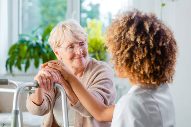 istock Disabled senior woman with a nurse 1160184298