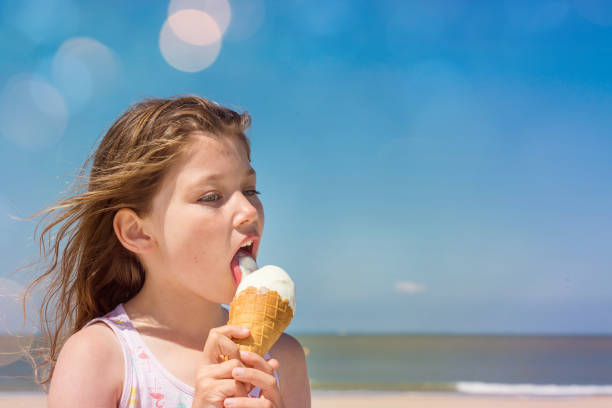 istock BEAUTIFUL YOUNG GIRL EATING AN ICE CREAM 1160184342