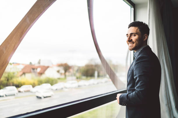 istock A young businessman in a suit posing near a window 1160185500
