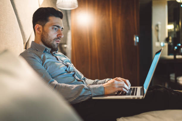 istock A young man working late on his business trip 1160185778