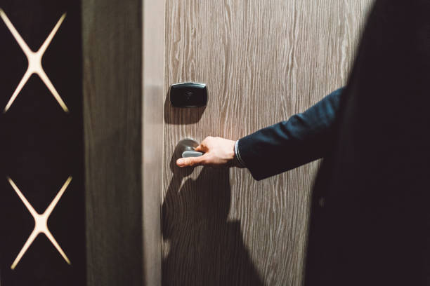 istock A man in a suit opening the door 1160186016