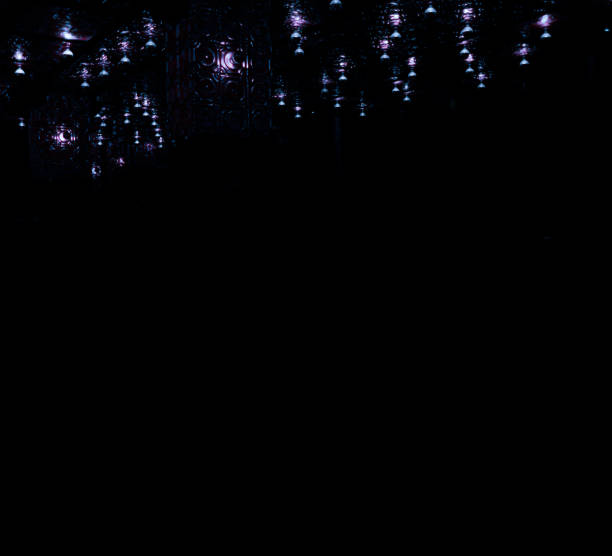 istock Water drop shaped ceiling lamps and wall reflection looks like rendered 3d abstract fantasy game scene with black background 1160187189