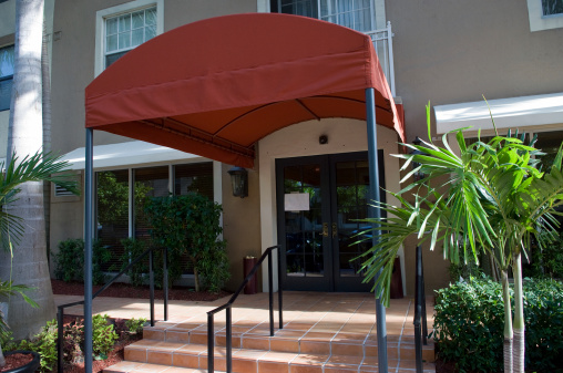 covered entrance of an medium size condominium building in South Florida