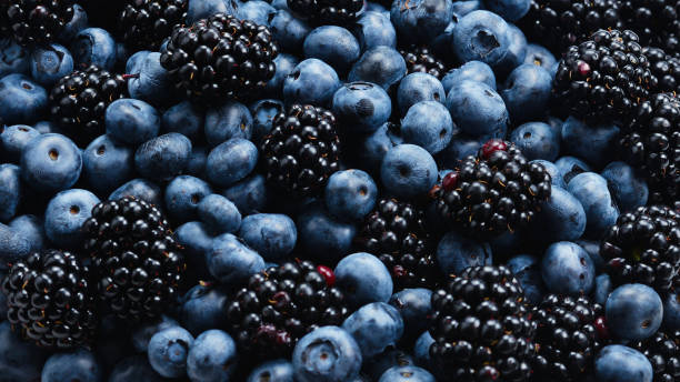 istock Blackberry and  blueberry background. Top view. 1160187863